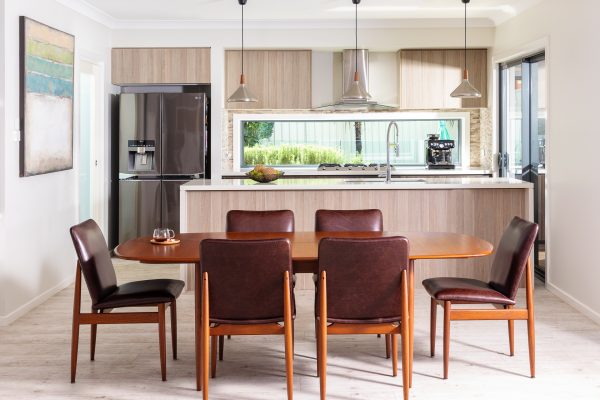 A Parker 92 D-Shape Table with 6 x Parker 118 Chairs with custom upholstery set in a beautiful dining room.